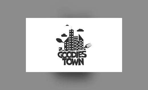 Wortbildmarke Goodies Town mit Stadtsilhouette, Gabel und Bäumen